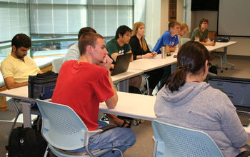 students sitting at tables during a cybersecurity seminar